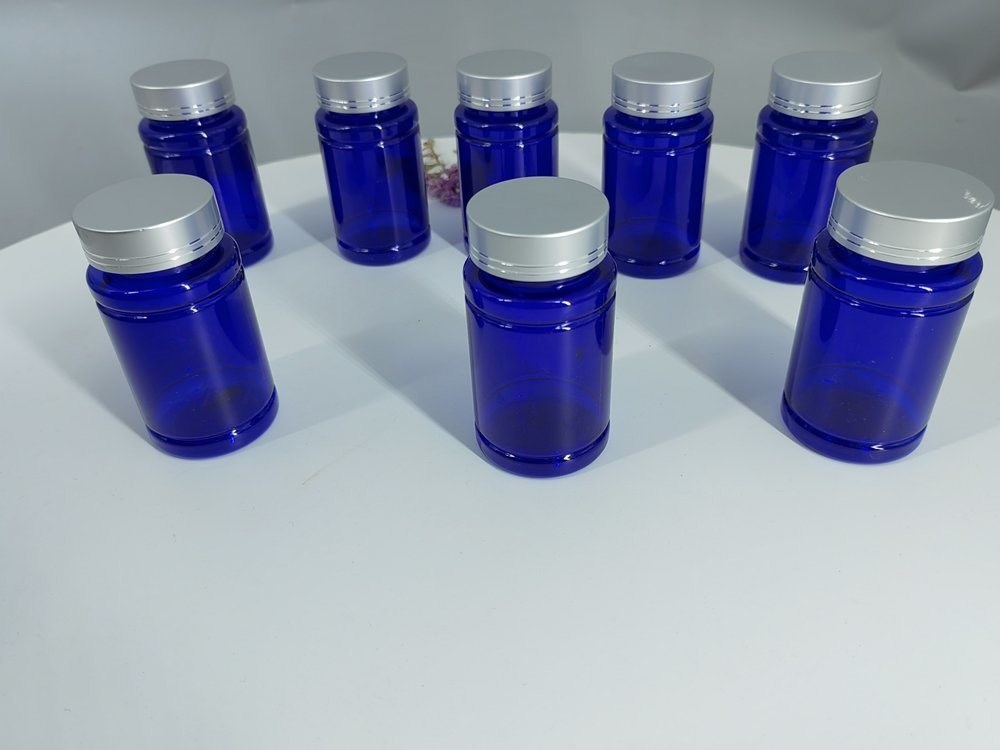 زجاجة حبوب منع الحمل من البلاستيك الزرقاء PET 100ml كبسولة حبوب منع الحمل مع غطاء المسمار الفضي